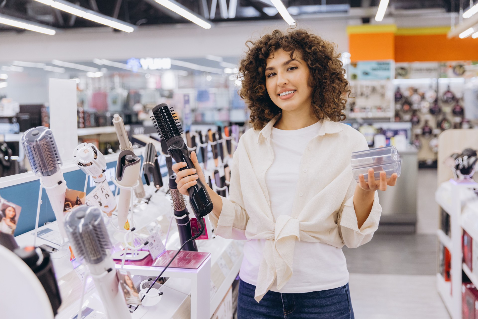 Woman Choosing Hair Styling Appliances in Electronics Store